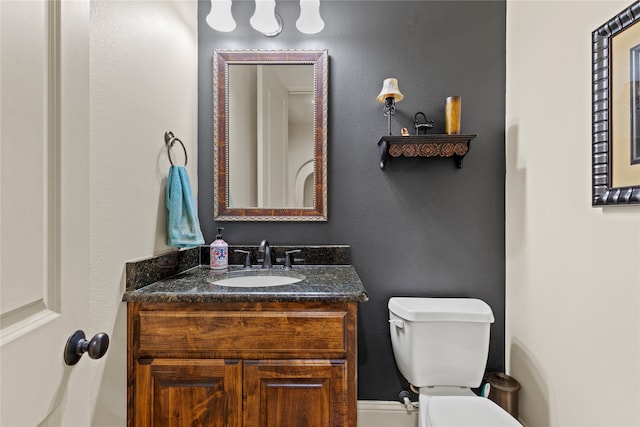 bathroom featuring toilet and vanity