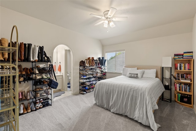 carpeted bedroom with ensuite bathroom, lofted ceiling, and ceiling fan