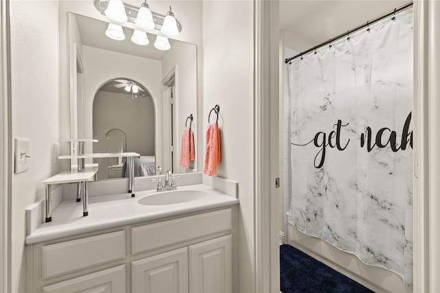 bathroom featuring shower / tub combo and vanity