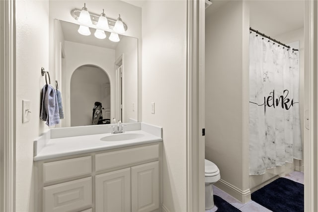 bathroom featuring toilet, vanity, and tile patterned flooring