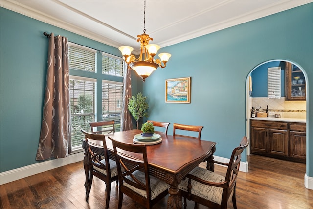 dining area with dark wood-type flooring and ornamental molding