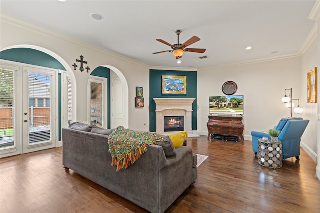 living room featuring ceiling fan, dark hardwood / wood-style floors, and crown molding