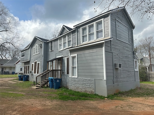 view of side of home featuring cooling unit