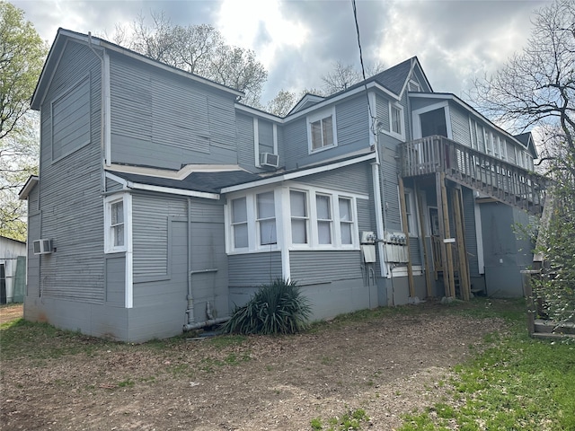 back of house with cooling unit and a deck