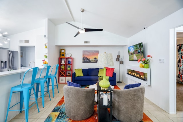 tiled living room with lofted ceiling and ceiling fan