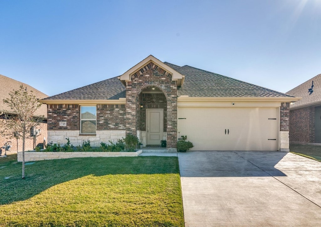 view of front facade featuring a front yard and a garage