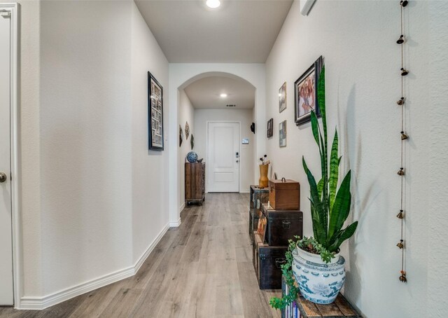 hallway with light hardwood / wood-style floors