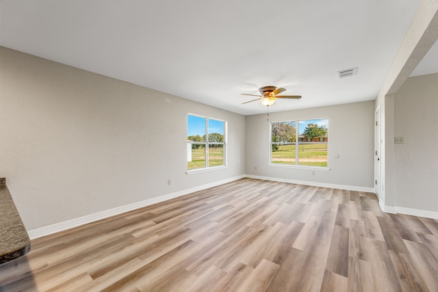 unfurnished room featuring ceiling fan and light wood-type flooring