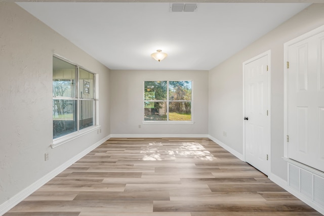 spare room with light hardwood / wood-style flooring