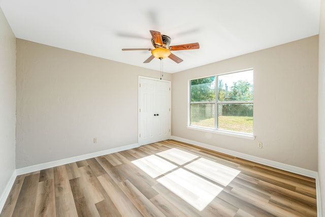 unfurnished room with ceiling fan and light hardwood / wood-style flooring