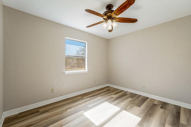 empty room with light hardwood / wood-style floors and ceiling fan