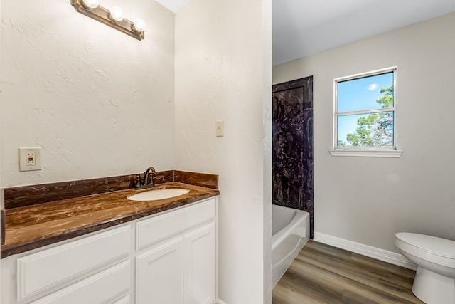 bathroom with hardwood / wood-style floors, vanity, and toilet