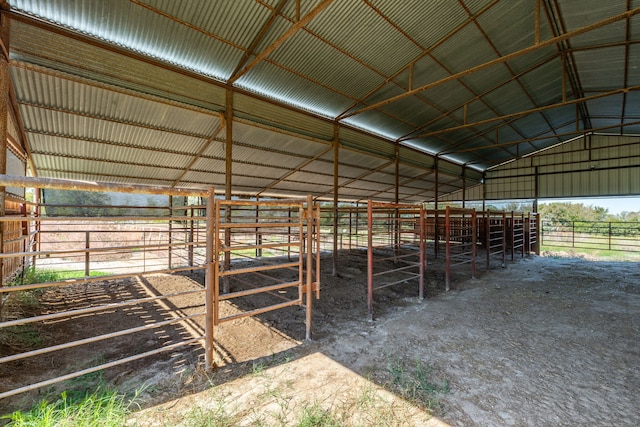 view of horse barn with a rural view