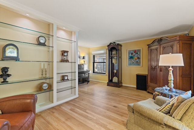 living room featuring light wood-type flooring and ornamental molding