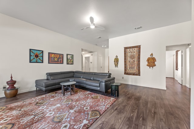 living room featuring ceiling fan and dark hardwood / wood-style floors