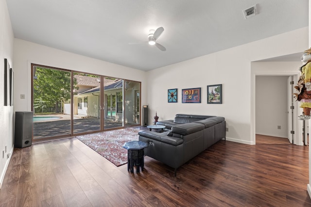 living room with dark hardwood / wood-style flooring and ceiling fan