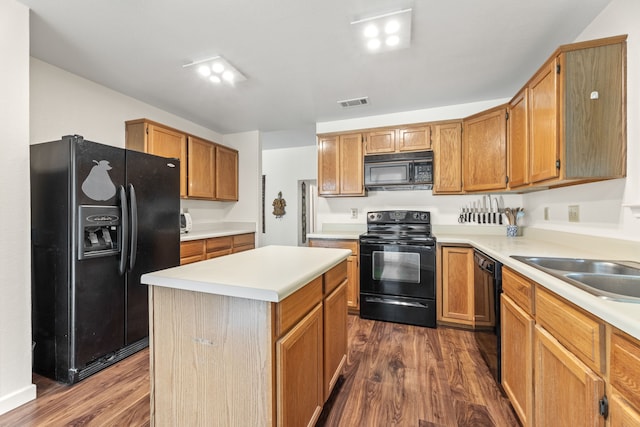 kitchen featuring black appliances, dark hardwood / wood-style floors, and a kitchen island