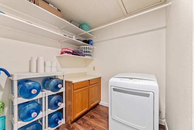 laundry area featuring a textured ceiling, dark hardwood / wood-style floors, and washer / dryer