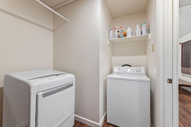 washroom with separate washer and dryer, a textured ceiling, and dark hardwood / wood-style flooring