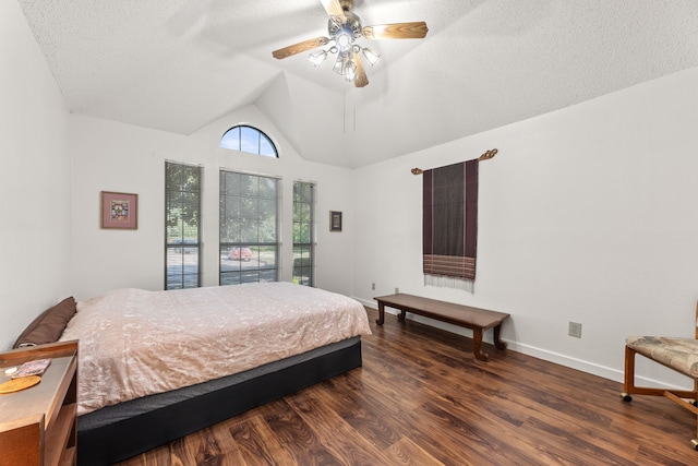 bedroom featuring a textured ceiling, vaulted ceiling, ceiling fan, and dark hardwood / wood-style floors