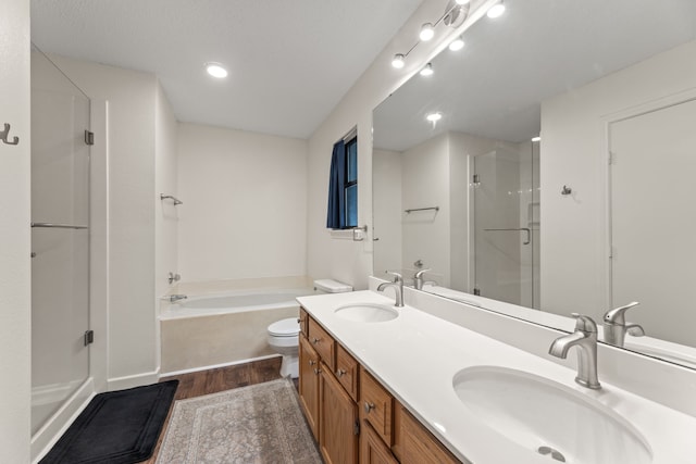 full bathroom featuring separate shower and tub, vanity, hardwood / wood-style flooring, and toilet