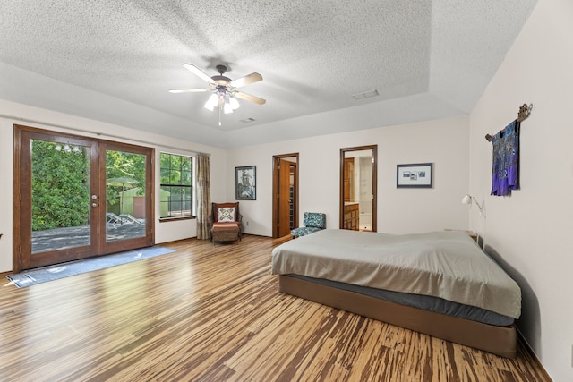 1901 Shady Hollow Ct, Garland, TX 75040 - bedroom with access to outside, a textured ceiling, wood finished floors, a ceiling fan, and a raised ceiling