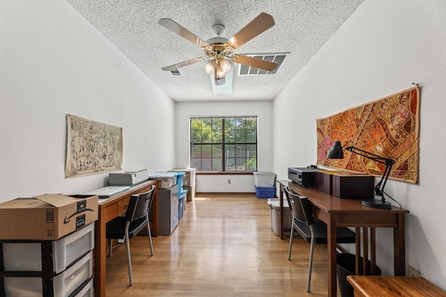 office area featuring a textured ceiling, light hardwood / wood-style flooring, and ceiling fan