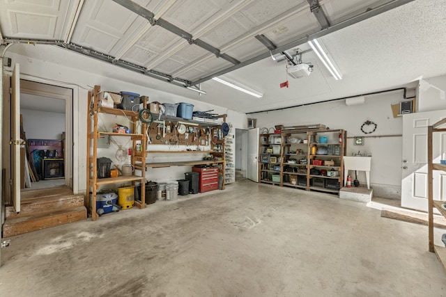 garage with a workshop area and a garage door opener