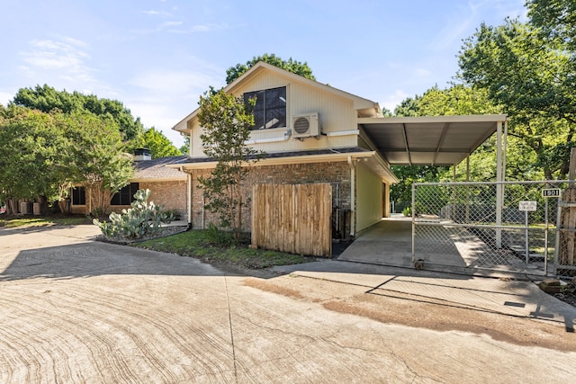 view of front of house with a carport and ac unit