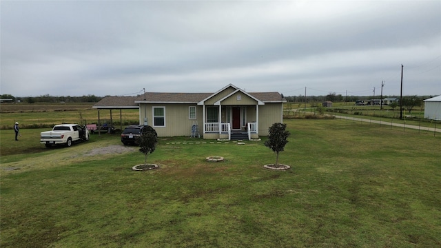 view of front of home featuring a front lawn, covered porch, and a carport