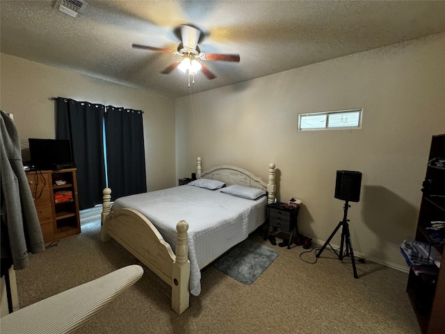 carpeted bedroom featuring a textured ceiling and ceiling fan