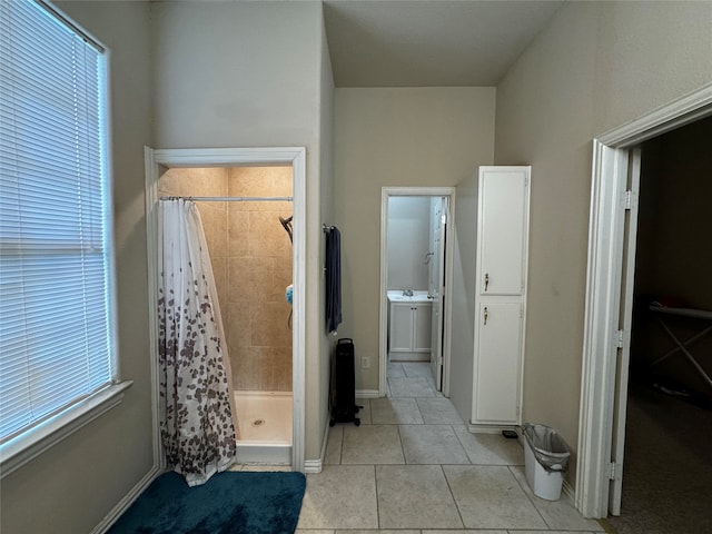 bathroom featuring a shower with curtain, a healthy amount of sunlight, and tile patterned floors