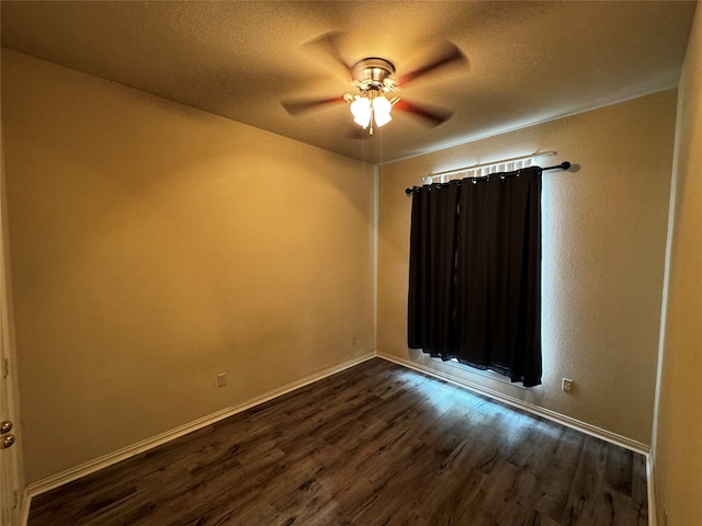 spare room featuring ceiling fan, a textured ceiling, and dark hardwood / wood-style flooring