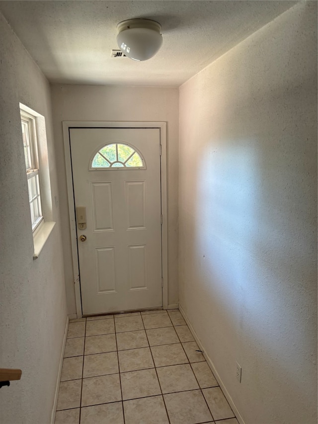 entryway with light tile patterned floors