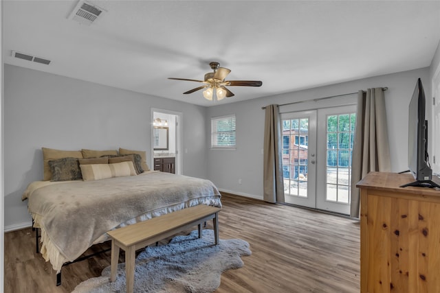 bedroom featuring access to outside, visible vents, wood finished floors, and french doors