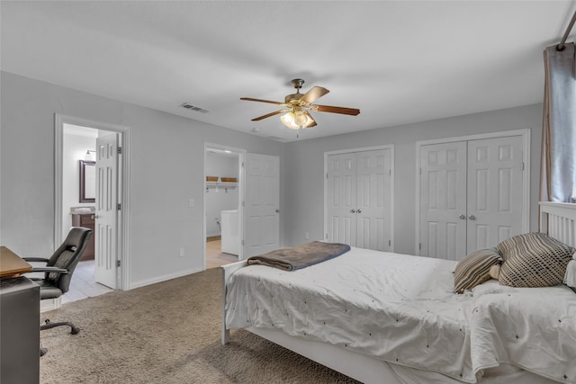 bedroom featuring light carpet, baseboards, visible vents, a ceiling fan, and multiple closets