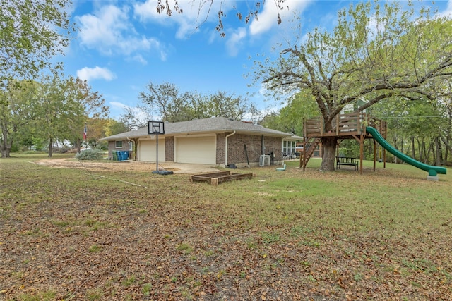 view of property exterior featuring a garage, a yard, a playground, and brick siding