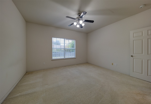 carpeted spare room with ceiling fan