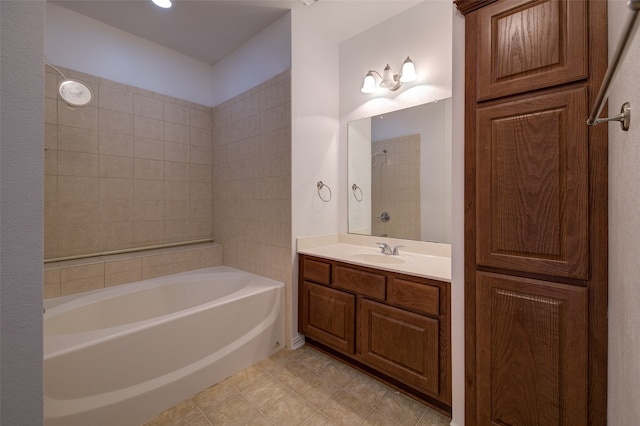 bathroom with tiled shower / bath and vanity