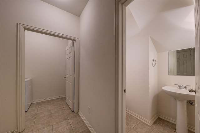 bathroom with separate washer and dryer, tile patterned flooring, sink, and lofted ceiling