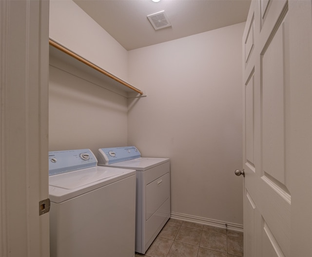 laundry room with separate washer and dryer and light tile patterned floors