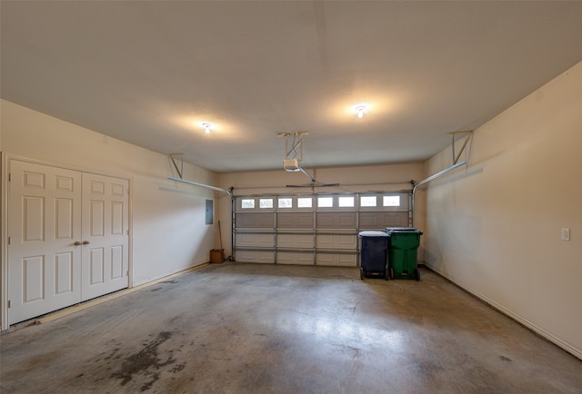 garage with electric panel and a garage door opener