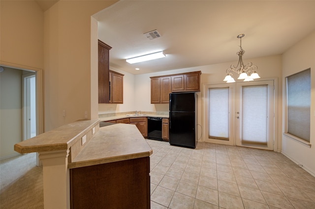 kitchen featuring black appliances, light tile patterned floors, hanging light fixtures, an inviting chandelier, and sink