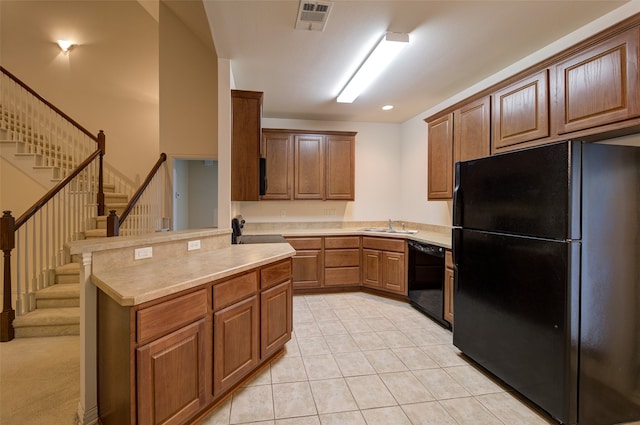 kitchen featuring kitchen peninsula, black appliances, sink, and light tile patterned flooring