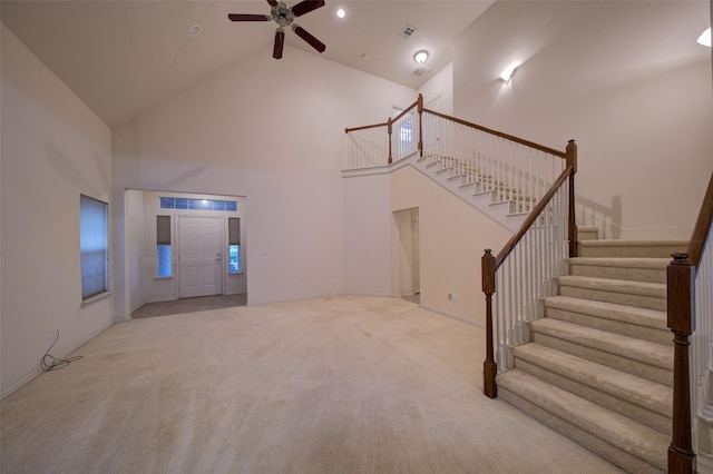 living room featuring high vaulted ceiling, light colored carpet, and ceiling fan