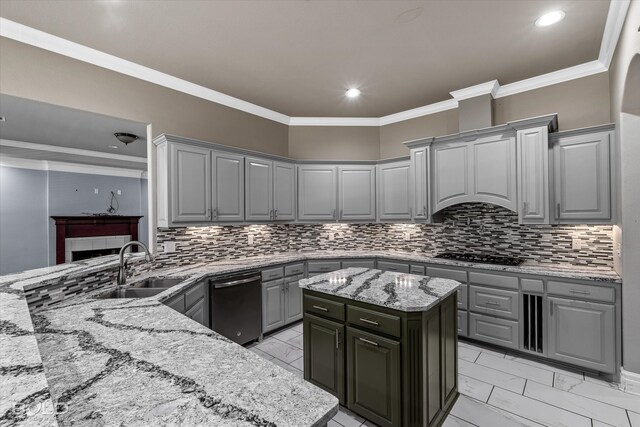 kitchen featuring ornamental molding, light stone counters, a kitchen island, and gray cabinetry