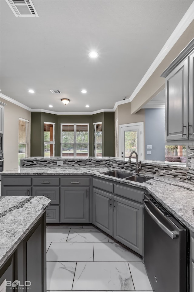 kitchen featuring dishwasher, sink, light stone counters, and gray cabinetry