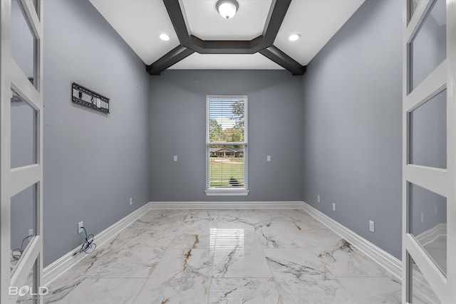 unfurnished room featuring beamed ceiling