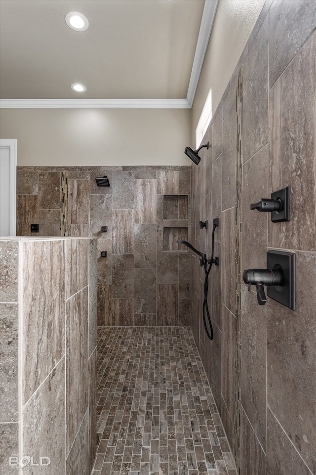 bathroom with ornamental molding and a tile shower