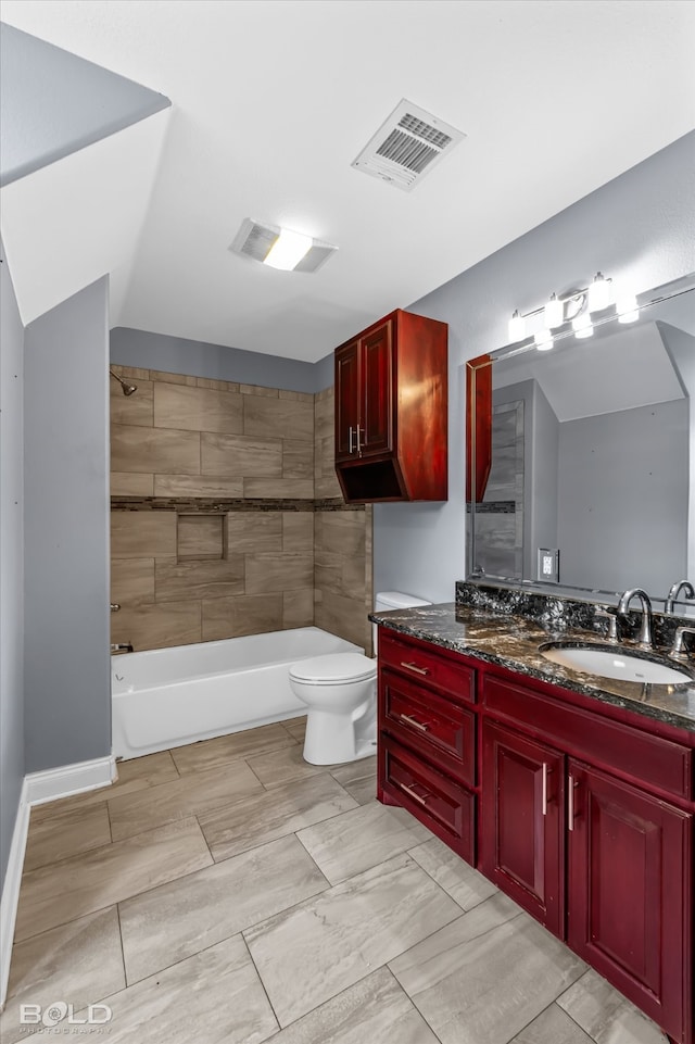 full bathroom with vanity, tiled shower / bath combo, and toilet